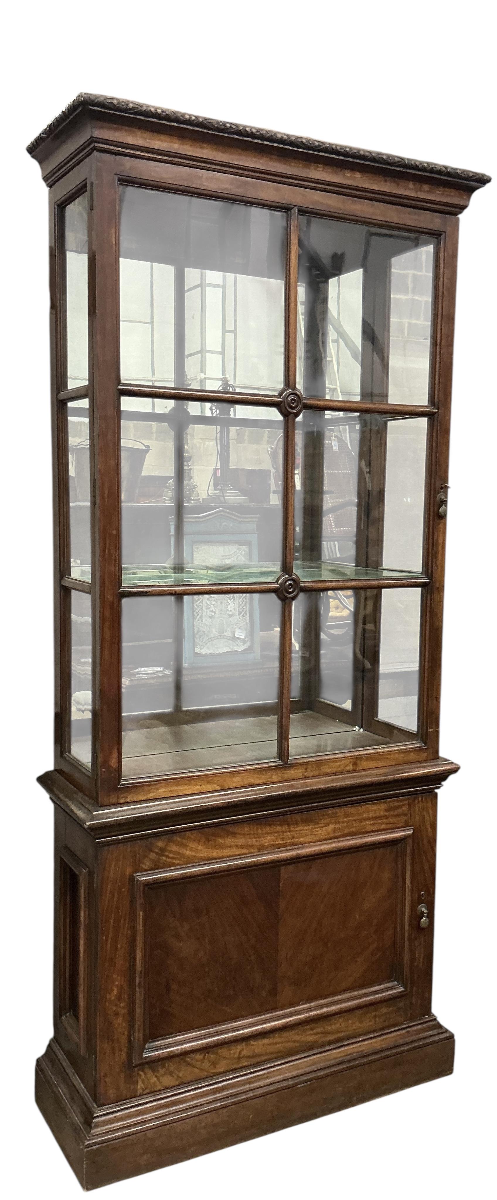 A pair of 1930's walnut vitrines, with single bar glazed doors over single panelled doors, on plinth feet, width 94cm, depth 35cm, height 212cm